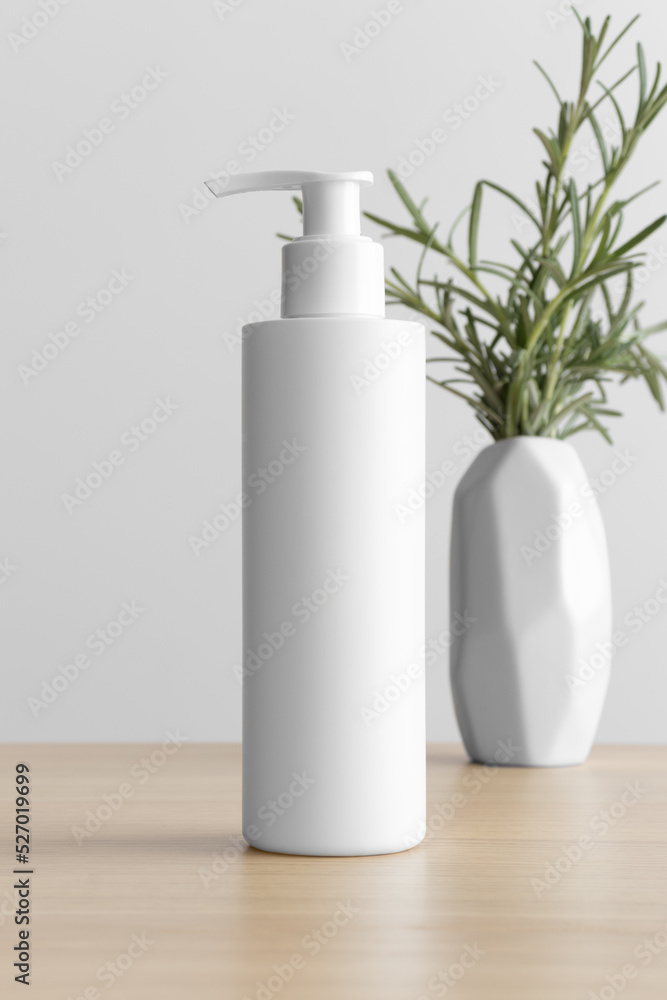 White cosmetic shampoo dispenser bottle mockup with a rosemary on the wooden table. White cosmetic shampoo dispenser bottle mockup with a rosemary on the wooden table.