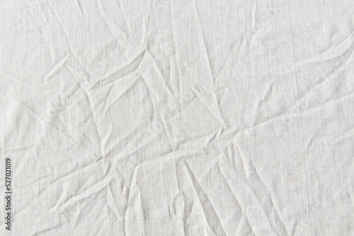 Natural crumpled white linen textile.