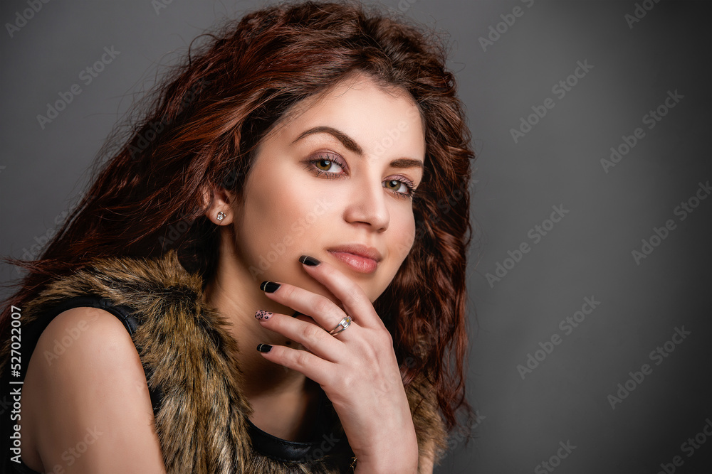 Portrait of a beautiful woman in the studio on the background. Portrait of a beautiful woman in the studio on the background.