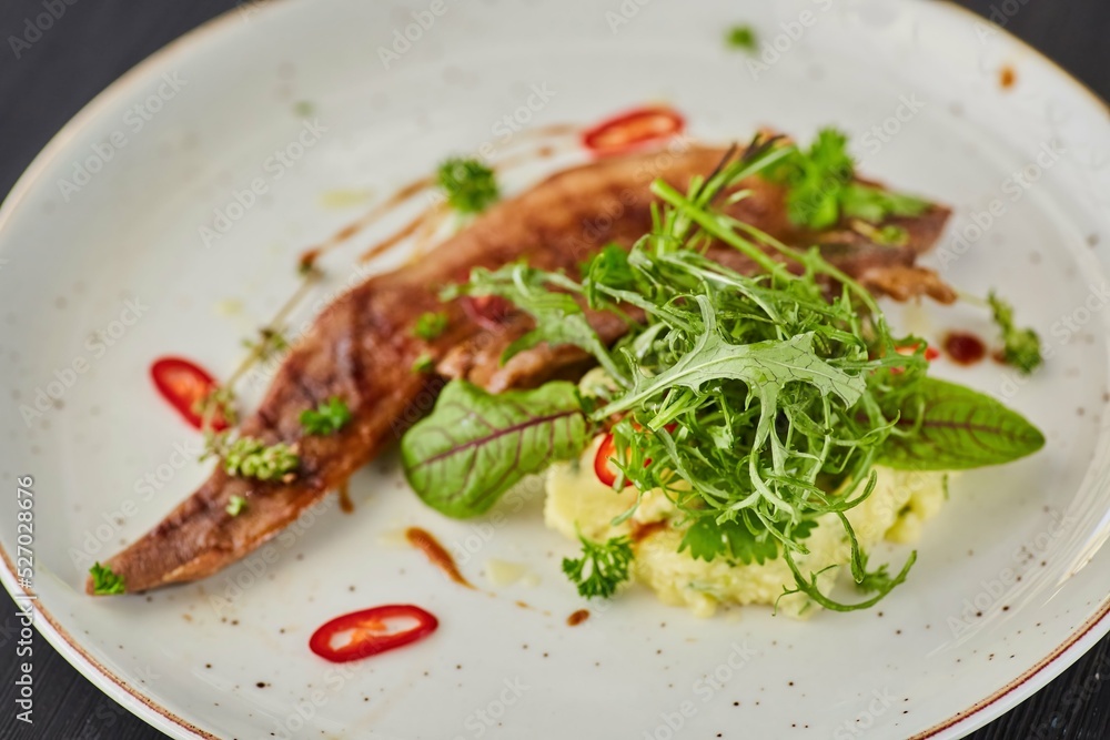 Beef tongue with sauce and herbs. A dish from the chef for serving in a restaurant.