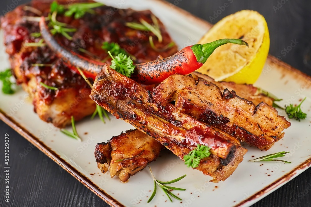 Grilled meat ribs with lemon. A dish from the chef for serving in a restaurant.
