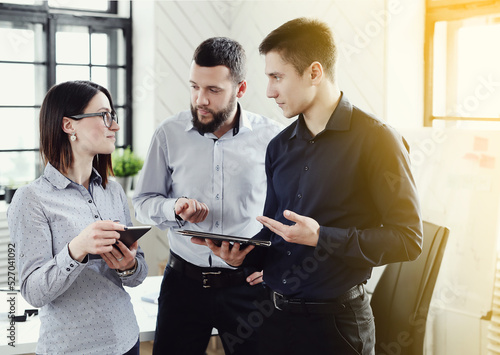 Collaborative Problem-Solving: Two Men and One Woman Engaged in a Productive Business Meeting