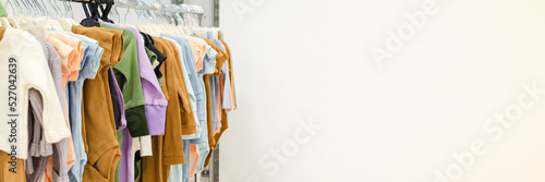 store rack with children's clothes. Floor hanger with clothes for newborns. Clothes Rail with a modern collection of children's cotton clothes for babies. selective focus