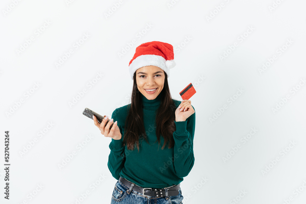 Online shopping for Christmas, happy brunette girl wearing santa hat Online shopping for Christmas, happy brunette girl wearing santa hat
