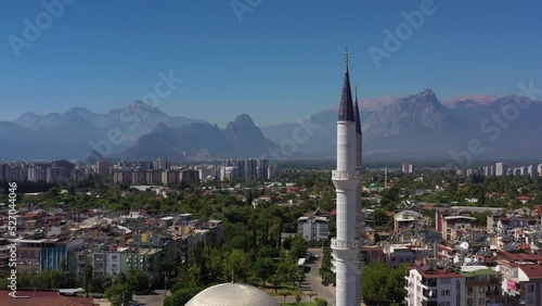 Minarets of Mosque, Cityscape and Mountains. Antalya Turkey. Aerial View. Drone Flies Upwards, Tilt Down. Crane Shot photo