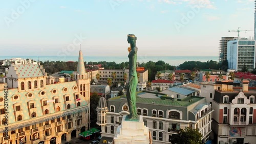 Batumi, Georgia - 8th august, 2022: aerial circular view around Medea statue in europe square in popular tourist destination Batumi in summer. photo