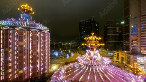 Timelapse of Casino building illuminated with traffic at night photo