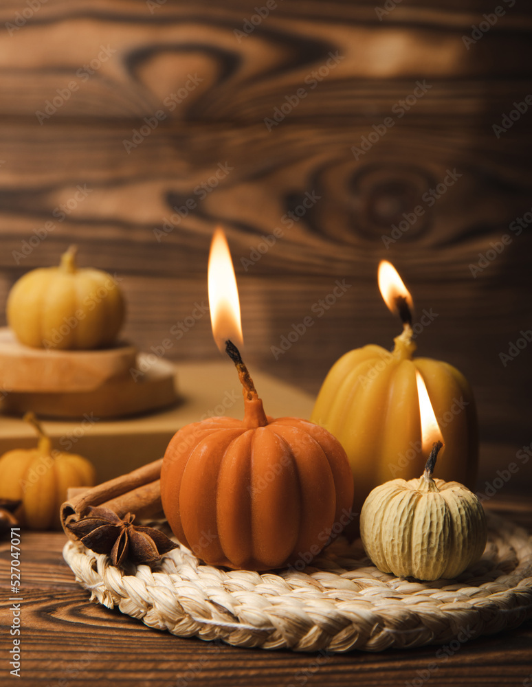 Autumn composition.Pumpkin candles,spicy star anise spices and cinnamon on a brown wooden background.Cozy home decor.Halloween concept.Happy Thanksgiving.Flat lay.Copy space. Autumn composition.Pumpkin candles,spicy star anise spices and cinnamon on a brown wooden background.Cozy home decor.Halloween concept.Happy Thanksgiving.Flat lay.Copy space.