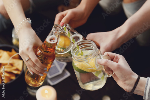 Get the party started with this fun and vibrant stock photo of a group of people enjoying food and drinks in the kitchen
