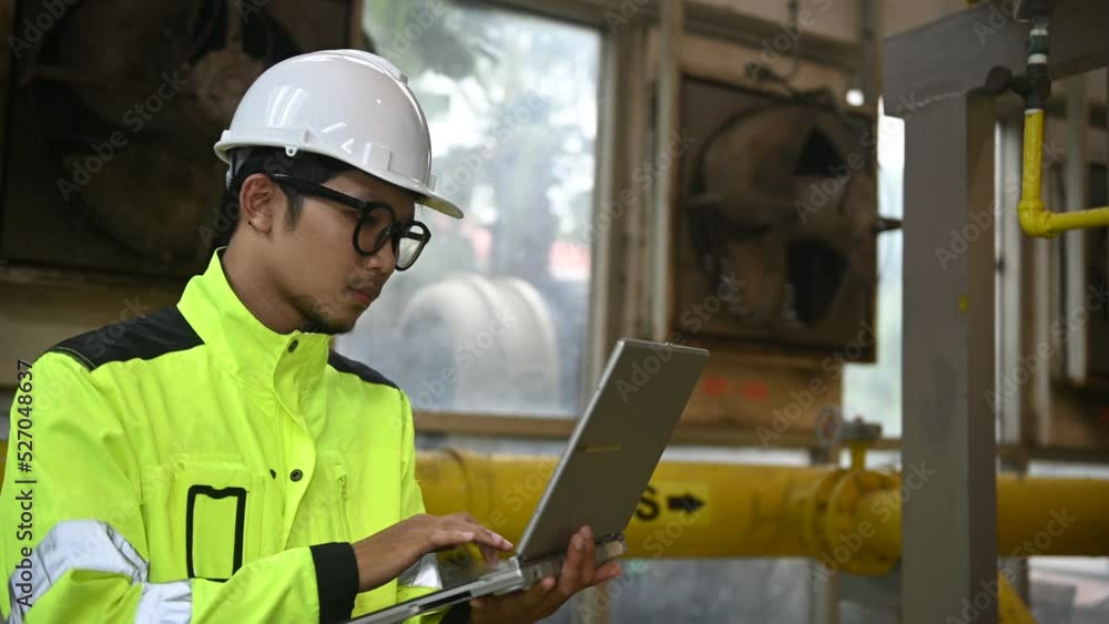 custom made wallpaper toronto digitalAsian engineer wearing glasses working in the boiler room,maintenance checking technical data of heating system equipment,Thailand people