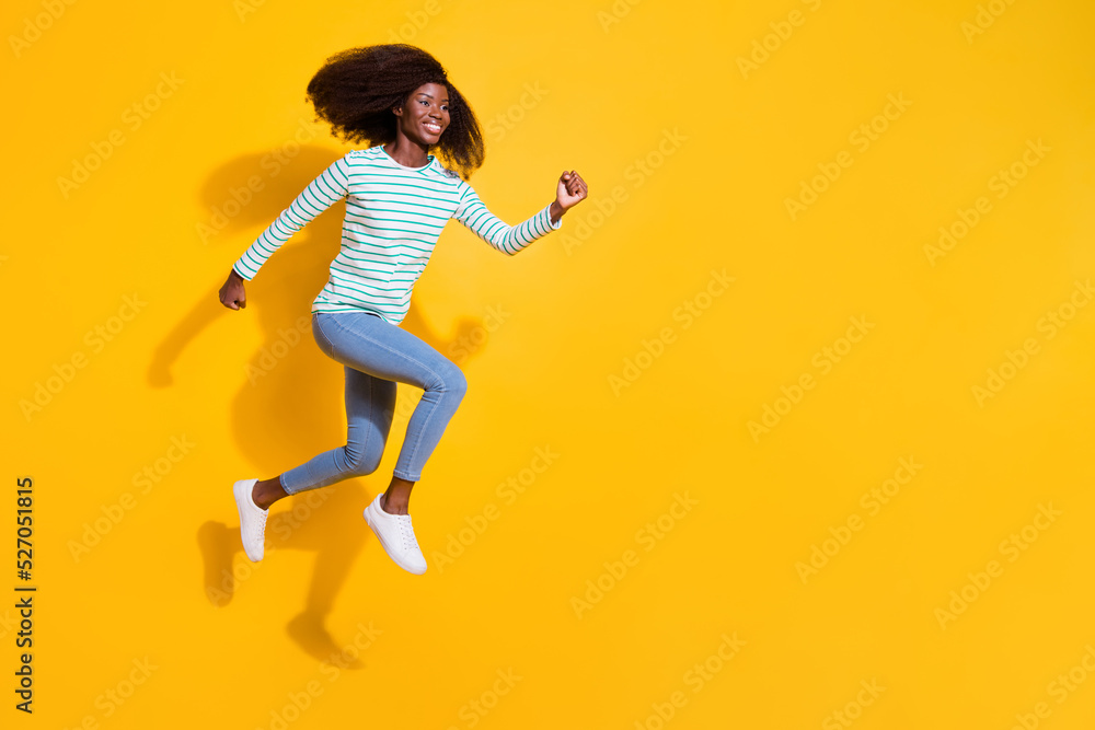 Full length profile portrait of excited sportive person look running jump empty space isolated on yellow color background