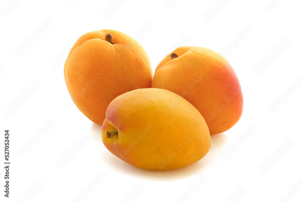 Three big flat apricots  isolated on white