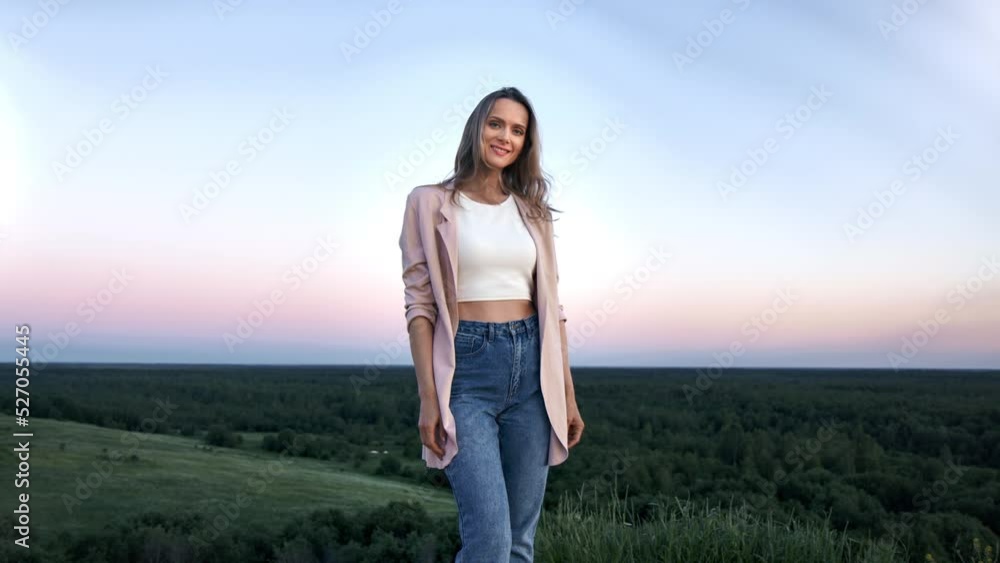 Portrait smiling casual woman posing on mountain peak at sunset picturesque sky nature landscape Portrait smiling casual woman posing on mountain peak at sunset picturesque sky nature landscape