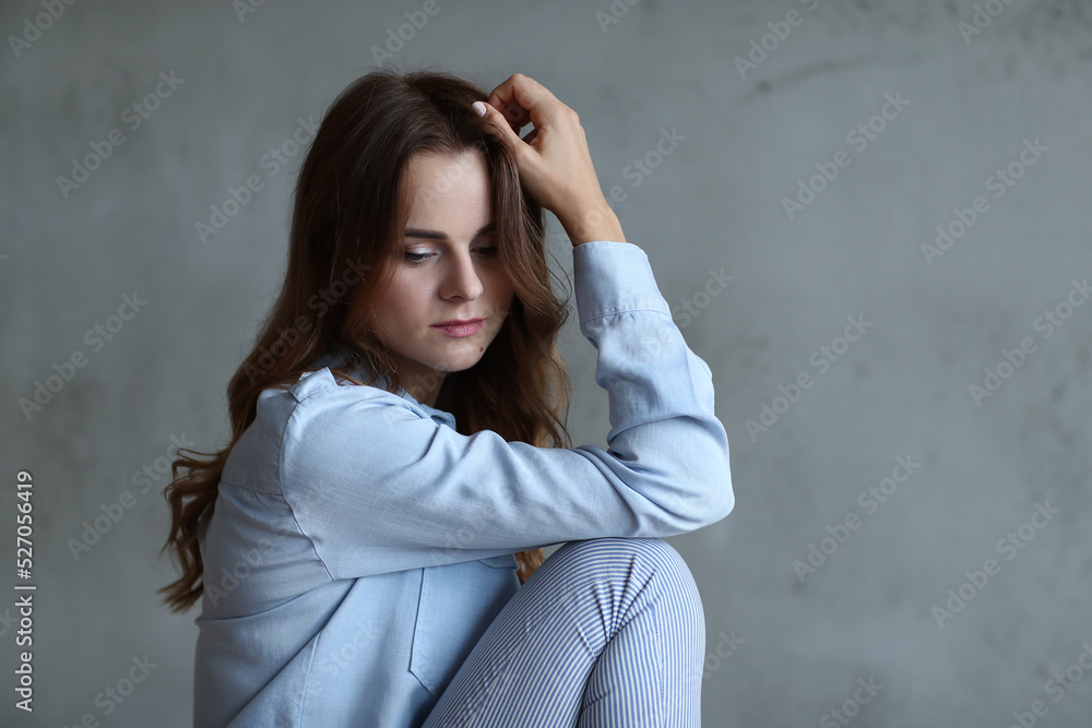 Chic and Confident: Woman Strikes a Pose on a Grey Studio Background, Embodying Modern Style and Elegance Chic and Confident: Woman Strikes a Pose on a Grey Studio Background, Embodying Modern Style and Elegance