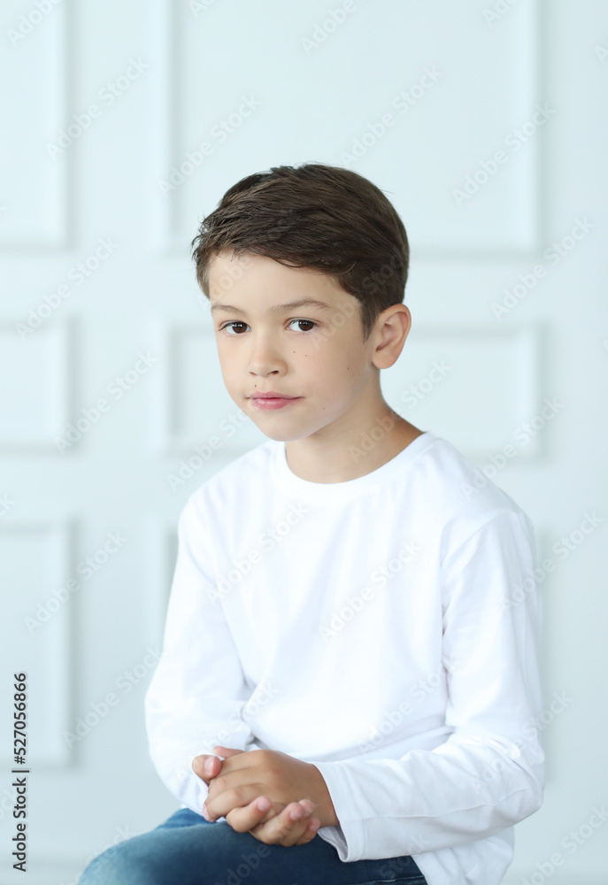 Childhood. Boy in white shirt posing portrait photo in studio Childhood. Boy in white shirt posing portrait photo in studio