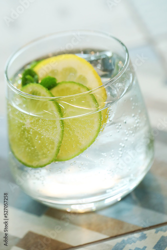 Mojito cocktail with lime and mint in highball glass on a grey on background