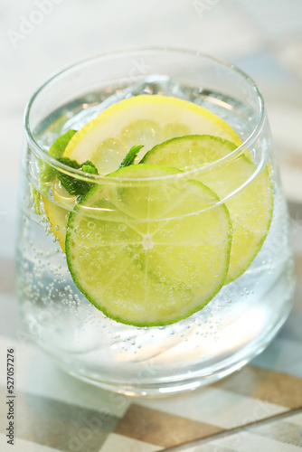 Mojito cocktail with lime and mint in highball glass on a grey on background