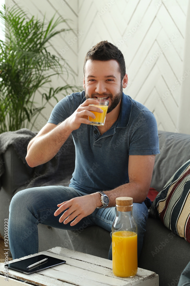 Fototapeta premium Handsome young man with beard using laptop at home