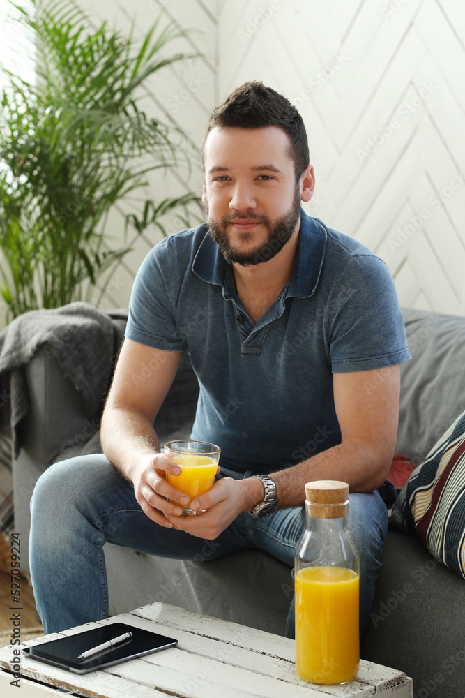 Handsome young man with beard using laptop at home Handsome young man with beard using laptop at home