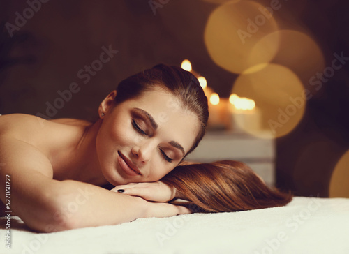 Massage. Beautiful girl in spa salon, a woman laying on a bed with candles in the background, spa, beautiful lady, petite girl, classic beauty, relaxing, gorgeous female, gorgeous lady