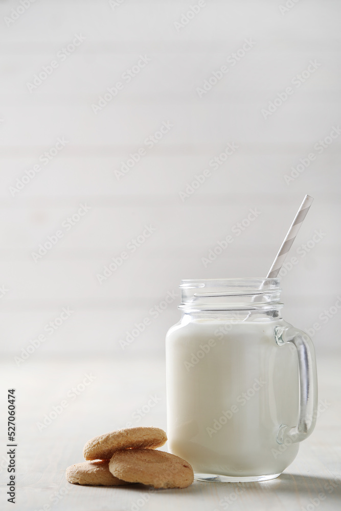 Homemade cooked healthy milk products for breakfast in a wooden bowl on the table and near a bottle of milk. Place for text. Fitness food, snack Homemade cooked healthy milk products for breakfast in a wooden bowl on the table and near a bottle of milk. Place for text. Fitness food, snack