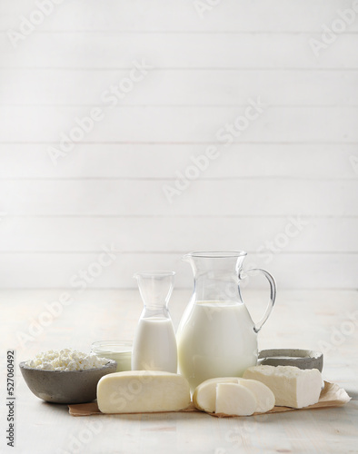 Homemade cooked healthy milk products for breakfast in a wooden bowl on the table and near a bottle of milk. Place for text. Fitness food, snack