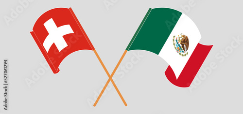 Crossed and waving flags of Switzerland and Mexico