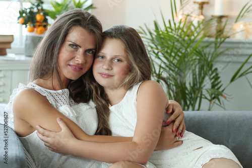 Loving Mother and Daughter Sharing a Tender Moment on a Cozy Sofa © racool_studio