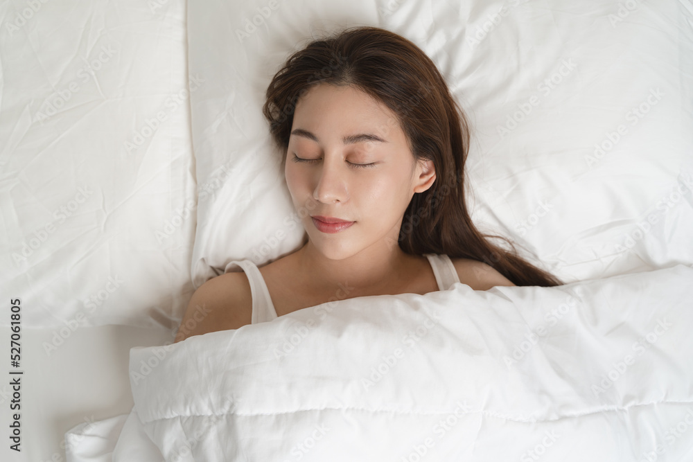 Top view of beautiful woman sleeping well on white soft pillow on the bed at home. Top view of beautiful woman sleeping well on white soft pillow on the bed at home.