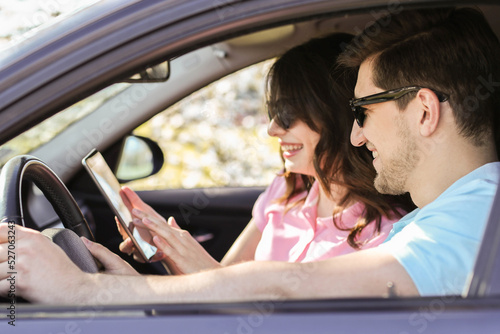 The happy couple travel in their car and looking at digital tablet © racool_studio