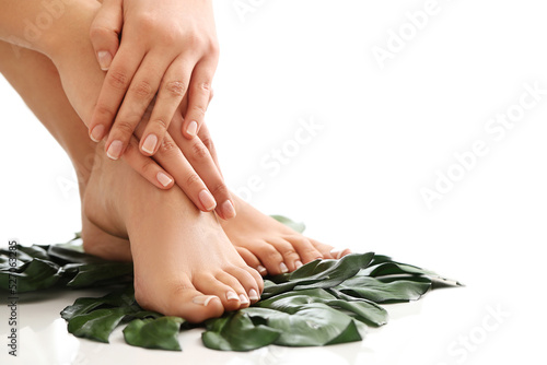 Perfect hands on women’s legs isolated on white background