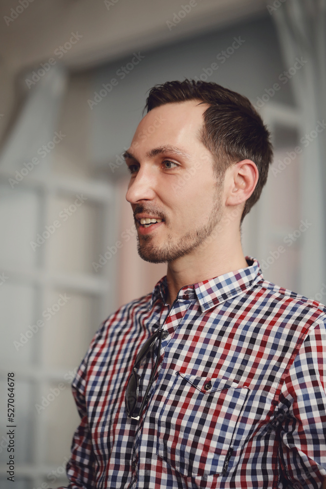 Picture of young brunette man looking away at home Picture of young brunette man looking away at home