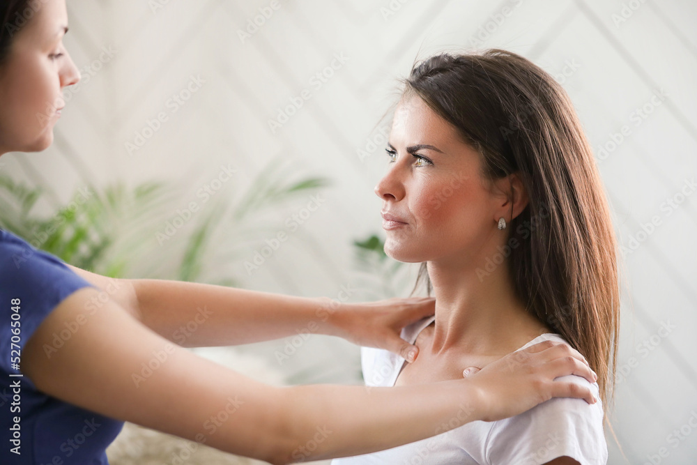 Professional massages the back of a young woman at home Professional massages the back of a young woman at home