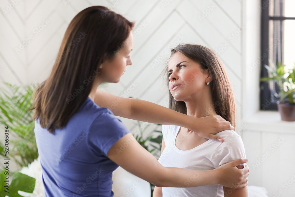 Professional massages the shoulder of a young woman at home Professional massages the shoulder of a young woman at home