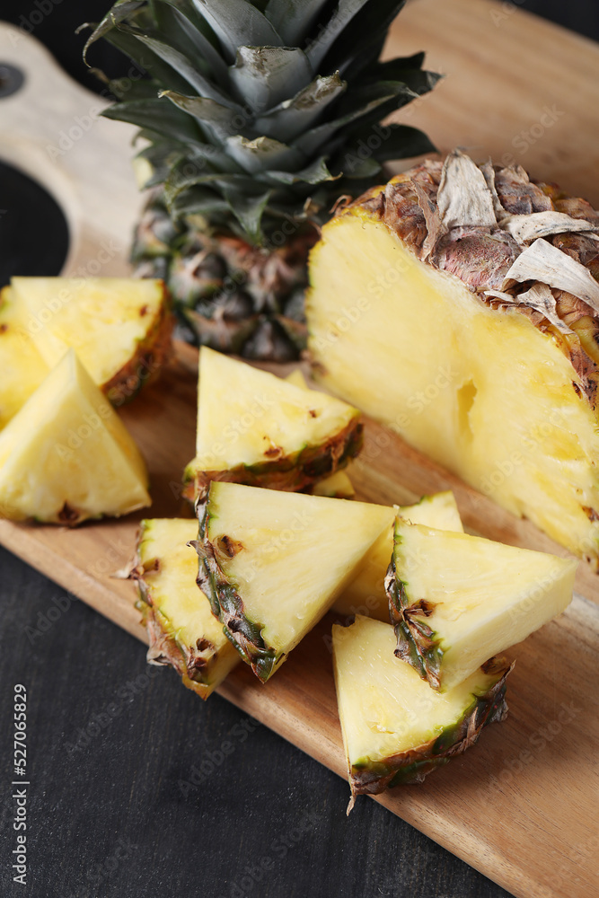 Fresh tasty juicy sliced pineapple on wooden board Fresh tasty juicy sliced pineapple on wooden board