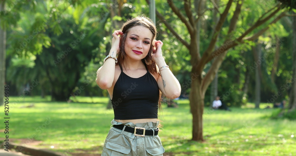 Pretty girl feeling relaxed posing in outdoor park Pretty girl feeling relaxed posing in outdoor park