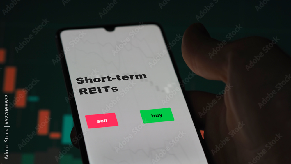 Naklejka premium An investor's analyzing the reit on screen. A phone shows the ETF's prices short-term REITs