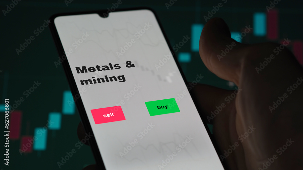 An investor's analyzing the stocks on screen. A phone shows the ETF's prices metals & mining An investor's analyzing the stocks on screen. A phone shows the ETF's prices metals & mining