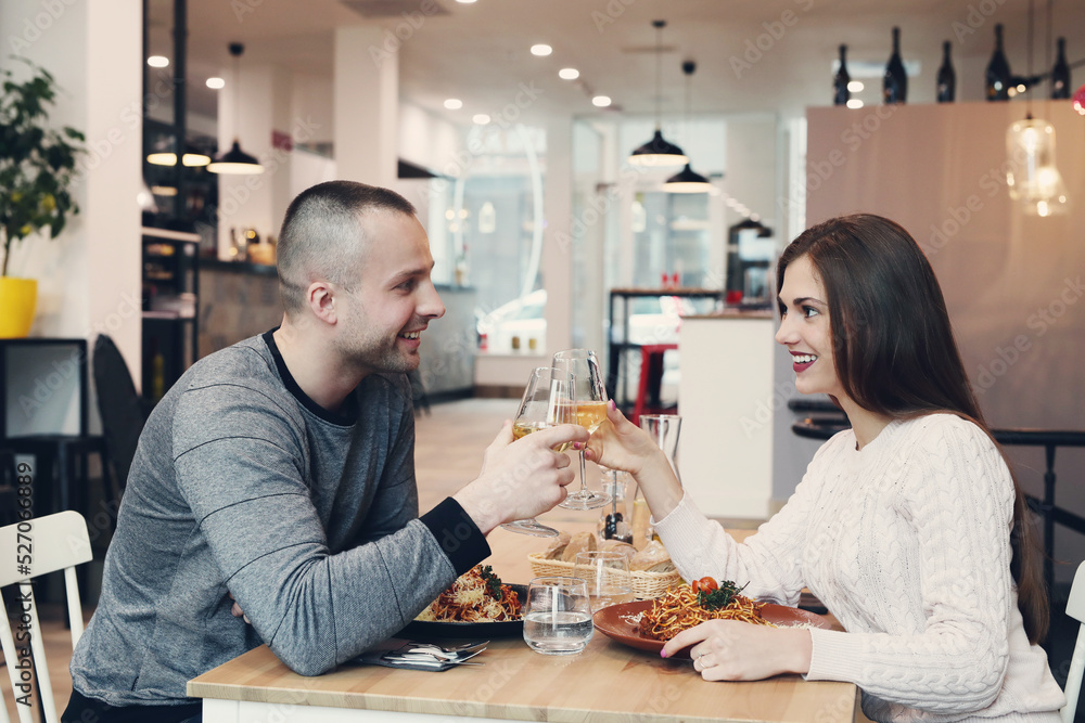Fototapeta premium Young couple sitting in a restaurant for a romantic dinner