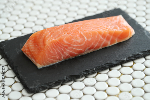 Picture of fresh juicy raw salmon on a black cutting board