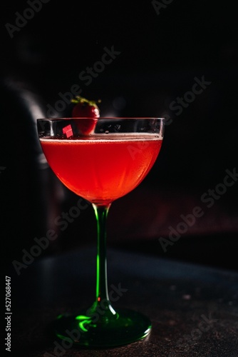 Strawberry daiquiri cocktail in a glass from above with a strawberry decoration photo