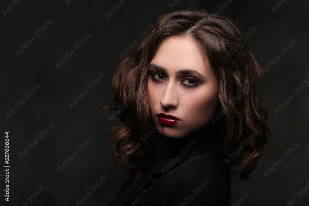 Photo of beautiful young girl with makeup on black background