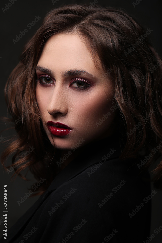 Fototapeta premium Photo of beautiful young girl with makeup on black background