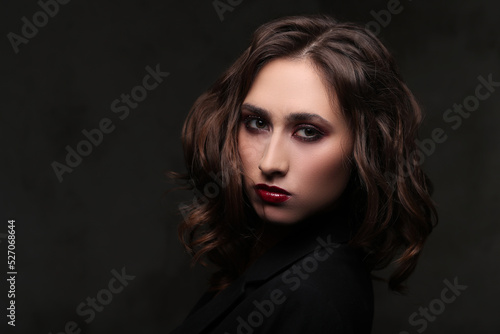 Photo of beautiful young girl with makeup on black background