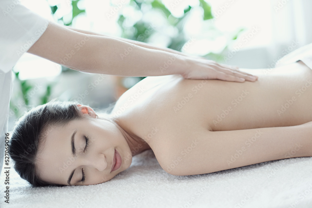 Fototapeta premium Women’s hands giving relaxing back massage in the spa salon
