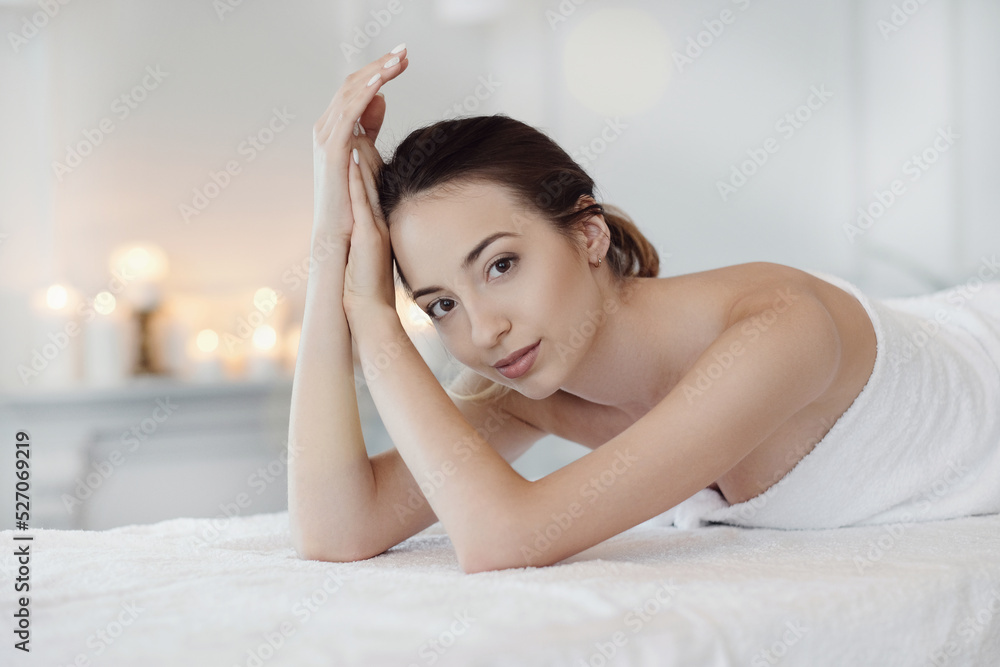 Relaxed beautiful young woman lying on the couch after massage in the spa Relaxed beautiful young woman lying on the couch after massage in the spa