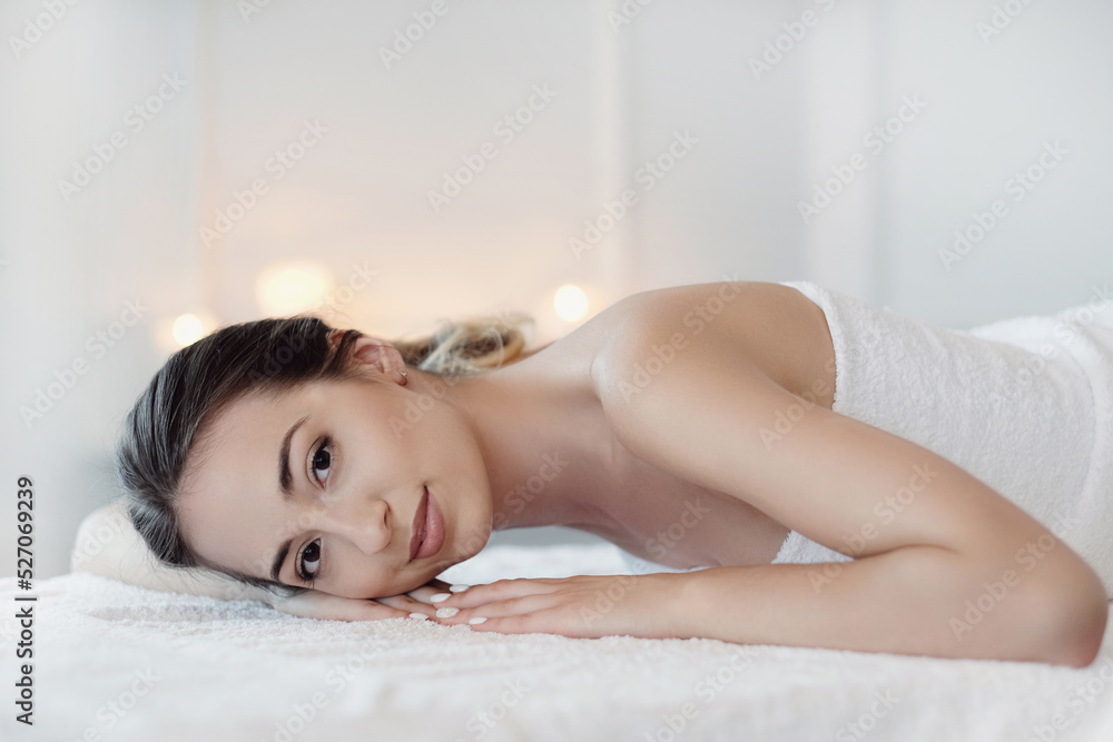 Relaxed beautiful young woman lying on the couch after massage in the spa salon Relaxed beautiful young woman lying on the couch after massage in the spa salon