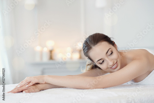 Relaxed beautiful young woman lying on the couch after massage in the spa