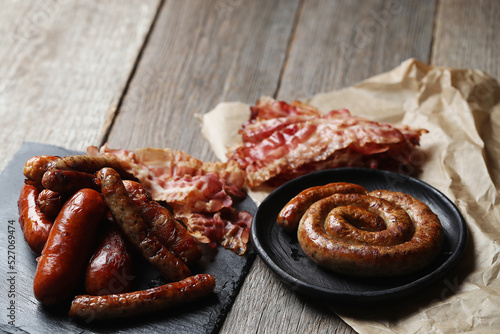 Delicious homemade hot grilled sausages on a wooden background photo