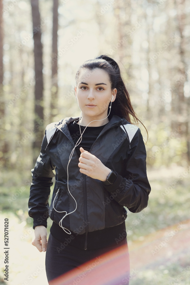 Photo of a young beautiful brunette woman running early in the morning in nature Photo of a young beautiful brunette woman running early in the morning in nature